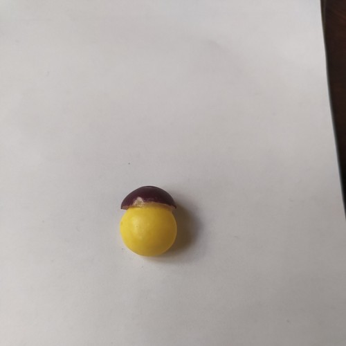 Deformed yellow skittle with - deformed,
