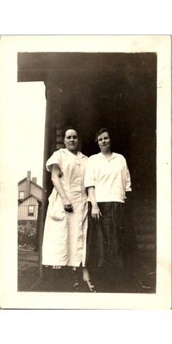 Two women outside wooden house - wooden,