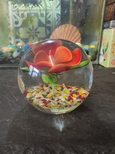 hand-blown art glass paperweight with an internal floral design.