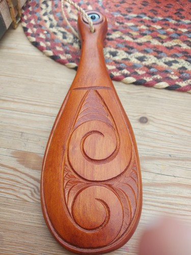 Maori hand carved paddle with - hand,