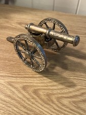 vintage ornamental silver-plated cannon. It is a decorative item