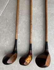 Three antique vintage golf clubs