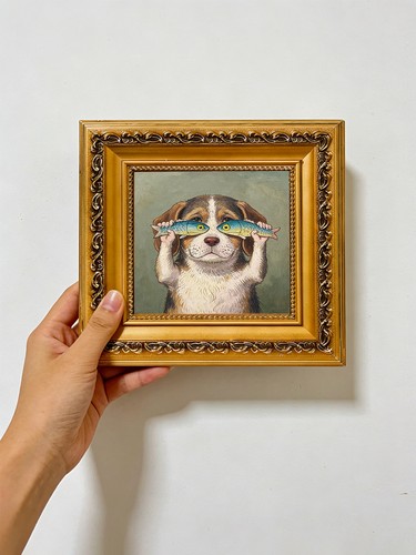 Dog holding fish like - fish,