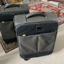 2 Large And Small Sets Of Tripp Suitcases. Grey with Lemon Trim. 4 Wheels. Used