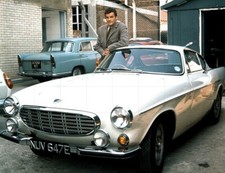 ROGER MOORE with White Volvo
