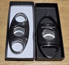 Two Cigar cutters one is