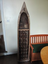 Large carved wooden boat incorporate wine rack and drop-down bar