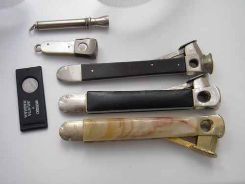 Cigar cutters and one - cigar,