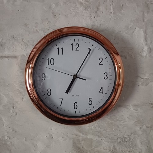Copper coloured wall clock