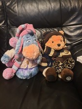 1 limited edition winnie pooh  and 1 limited edition eyore in winter clothing