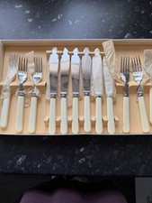 Sheffield stainless steel fish knives and forks with faux ivory handles. 6 Set