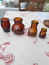 Three Brown Bovril Bottles