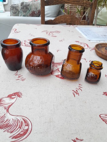Three brown bovril bottles - three,
