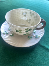A Belleek  Green Shamrock cup and saucer  with Black 2nd /3rd marks c 1926
