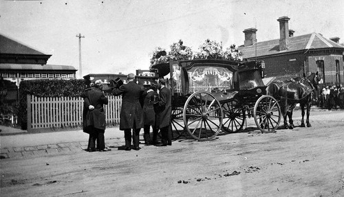 Coffin being placed - being,