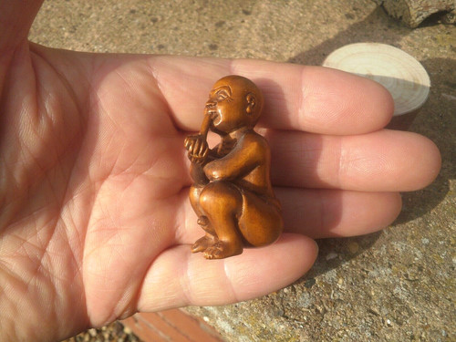 Hand carved wood netsuke man - hand,