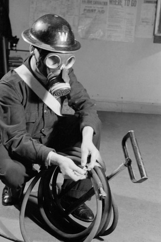 Warden wearing gas mask - wearing, a