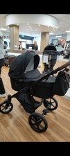 Venicci Pram System with Carry Cot and Rain Cover. Black And Brown.