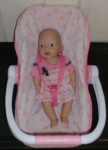 Baby girl doll pink - in, car