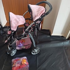 Doll's double buggy and bag of