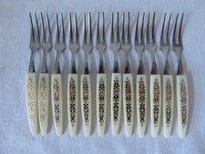 Dozen little stainless forks