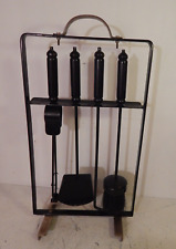 A retro metal and brass fire companion tool set