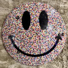 Ex police riot shield……. With a big smiling colourful spotty face…