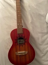 Winzz Tenor Ukulele with a sunburst finish and a sun-engraved soundhole design