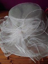 Woman's fancy hat for wedding or formal occasion, cream, folds flat, 