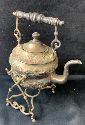 Vintage ornate tea kettle with - tea,