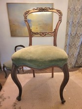 Four Victorian Walnut Balloon Back Chairs.