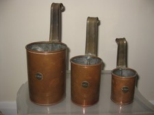 Vintage copper and brass measuring jugs