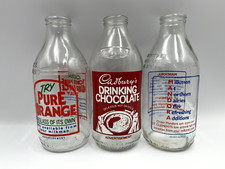 Three vintage milk bottles
