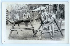 Cute blond kids playing on wooden saw horses; photo postcard RPPC 
