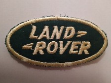 Land Rover dark green and light yellow oval shaped badge