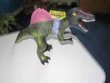 large rubber dinosaur makes a