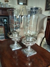 Silver plated candle holder/ hurricane lamps, with glass shades.