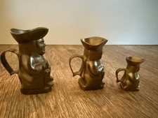 Set of 3 brass toby jugs