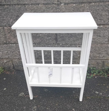 White wooden table with magazine rack
