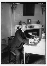 F. Lowden seated at desk