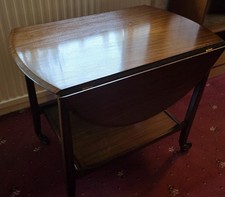 SMALL VINTAGE WOODEN DROP LEAF  TABLE WITH SHELF UNDERNEATH AND ON CASTERS