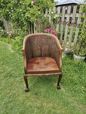 ANTIQUE BERGERE CHAIR ,carved ornate feet ,ratten backed 