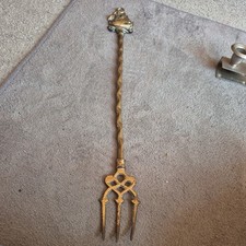 brass toasting fork figure to