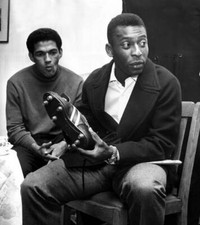 Brazilian football star Pele looking at a pair of football boots a- Old Photo