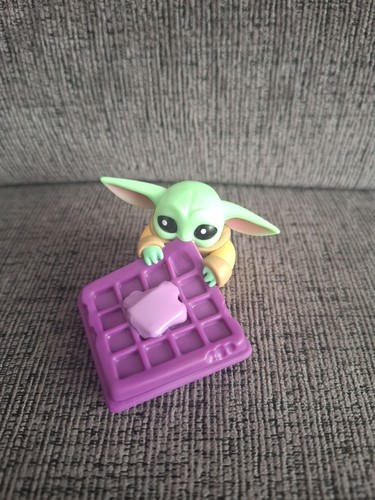 Grogu eating purple - a,
