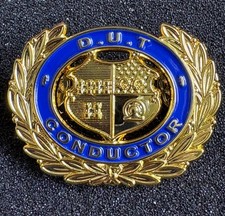 DUBLIN UNITED TRAMWAYS CO CONDUCTOR  ENAMEL-TYPE BADGE