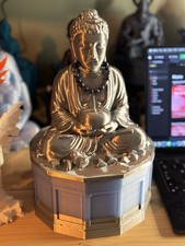 A striking large silver Buddha