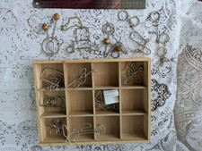 Wooden box of 12 metal puzzles