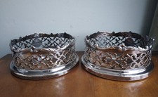 Pair Silver plated wine Champagne bottle coasters with crested button , pierced