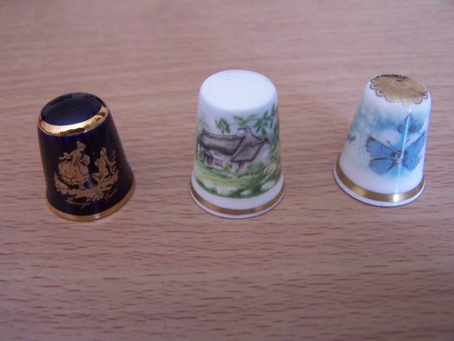 Three china thimbles - three,